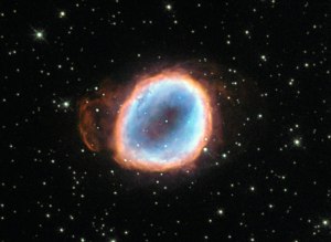 A dying star’s final moments are captured in this image from the NASA/ESA Hubble Space Telescope. The death throes of this star may only last mere moments on a cosmological timescale, but this star’s demise is still quite lengthy by our standards, lasting tens of thousands of years! The star’s agony has culminated in a wonderful planetary nebula known as NGC 6565, a cloud of gas that was ejected from the star after strong stellar winds pushed the star’s outer layers away into space. Once enough material was ejected, the star’s luminous core was exposed and it began to produce ultraviolet radiation, exciting the surrounding gas to varying degrees and causing it to radiate in an attractive array of colours. These same colours can be seen in the famous and impressive Ring Nebula (heic1310), a prominent example of a nebula like this one. Planetary nebulae are illuminated for around 10 000 years before the central star begins to cool and shrink to become a white dwarf. When this happens, the star’s light drastically diminishes and ceases to excite the surrounding gas, so the nebula fades from view. A version of this image was entered into the Hubble’s Hidden Treasures basic image competition by contestant Matej Novak.
