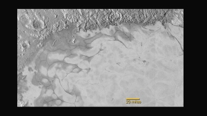 New Horizons discovers flowing ices in Pluto’s heart-shaped feature. In the northern region of Pluto’s Sputnik Planum (Sputnik Plain), swirl-shaped patterns of light and dark suggest that a surface layer of exotic ices has flowed around obstacles and into depressions, much like glaciers on Earth. Credits: NASA/JHUAPL/SwRI