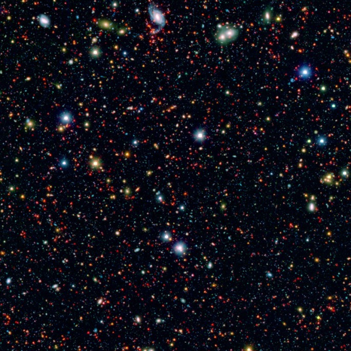 The picture is a combination of infrared data from Spitzer (red) and visible-light data (blue and green) from Japan's Subaru telescope atop Mauna Kea in Hawaii. These data were taken as part of the SPLASH (Spitzer large area survey with Hyper-Suprime-Cam) project. Credits: NASA/JPL/Spitzer/Subaru