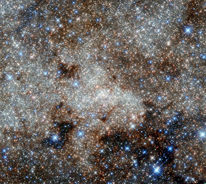 This image, not unlike a pointillist painting, shows the star-studded centre of the Milky Way towards the constellation of Sagittarius. The crowded centre of our galaxy contains numerous complex and mysterious objects that are usually hidden at optical wavelengths by clouds of dust — but many are visible here in these infrared observations from Hubble. However, the most famous cosmic object in this image still remains invisible: the monster at our galaxy’s heart called Sagittarius A*. Astronomers have observed stars spinning around this supermassive black hole (located right in the centre of the image), and the black hole consuming clouds of dust as it affects its environment with its enormous gravitational pull. Infrared observations can pierce through thick obscuring material to reveal information that is usually hidden to the optical observer. This is the best infrared image of this region ever taken with Hubble, and uses infrared archive data from Hubble’s Wide Field Camera 3, taken in September 2011. It was posted to Flickr by Gabriel Brammer, a fellow at the European Southern Observatory based in Chile. He is also an ESO photo ambassador.