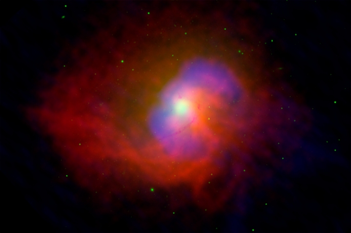 This composite image shows a vast cloud of hot gas (X-ray/red), surrounding high-energy bubbles (radio/blue) on either side of the bright white area around the supermassive black hole. By studying the inner regions of the galaxy with Chandra, scientists estimated the rate at which gas is falling toward the galaxy's supermassive black hole. These data also allowed an estimate of the power required to produce the bubbles, which are each about 10,000 light years in diameter. Surprisingly, the analysis indicates that most of the energy released by the infalling gas goes into producing jets of high-energy particles that create the huge bubbles, rather than into an outpouring of light as observed in many active galactic nuclei.